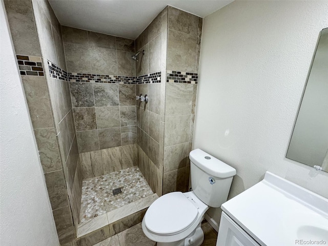 6640 S Heritage Pl W, Centennial, CO 80111 - bathroom featuring toilet, tiled shower, and vanity