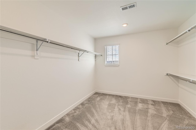 spacious closet with carpet floors and visible vents