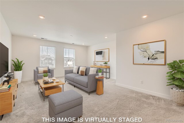 living room with recessed lighting, light colored carpet, visible vents, and baseboards