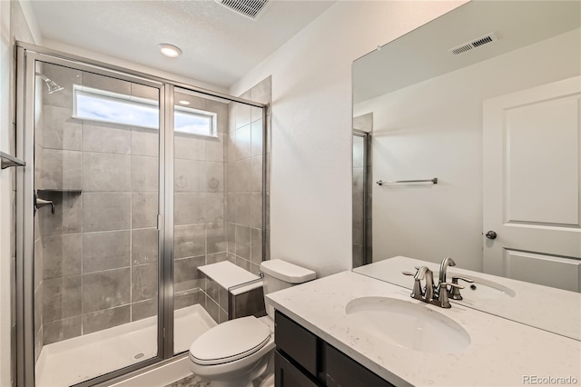 full bath featuring a stall shower, visible vents, vanity, and toilet