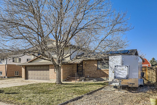 view of front of home featuring a garage and a front yard