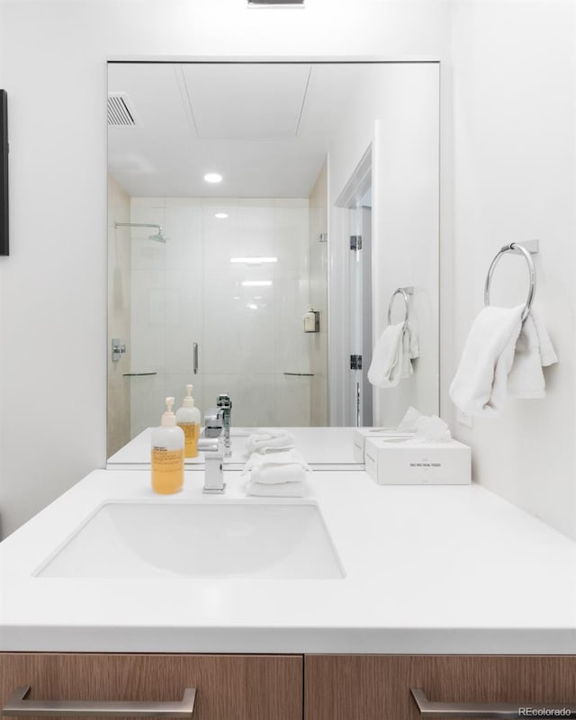 full bath featuring a shower stall, visible vents, and vanity