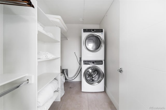 clothes washing area with laundry area and stacked washer and dryer