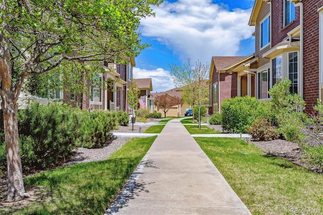 surrounding community with a yard and a residential view