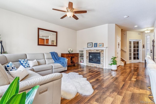 living area with a fireplace, wood finished floors, baseboards, ceiling fan, and recessed lighting