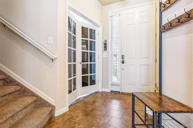entrance foyer featuring baseboards and stairway