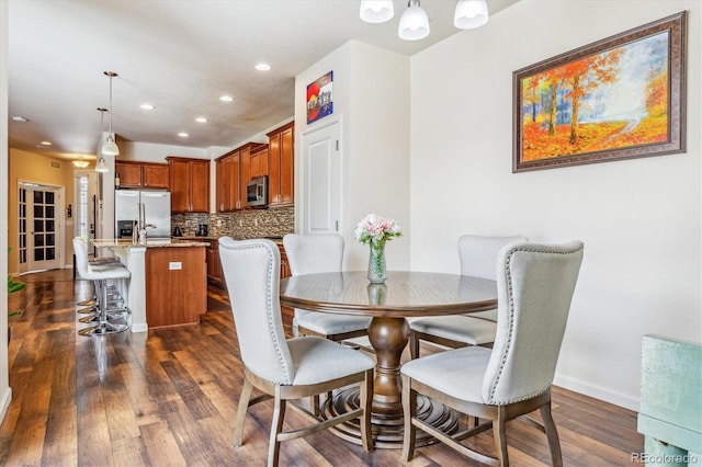 dining room featuring recessed lighting, baseboards, a chandelier, and dark wood finished floors