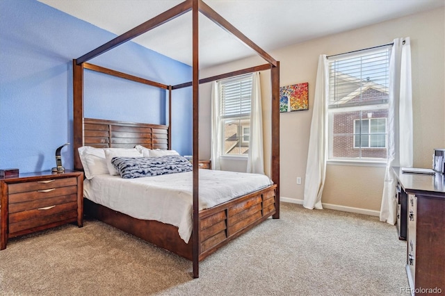 bedroom featuring baseboards and light colored carpet