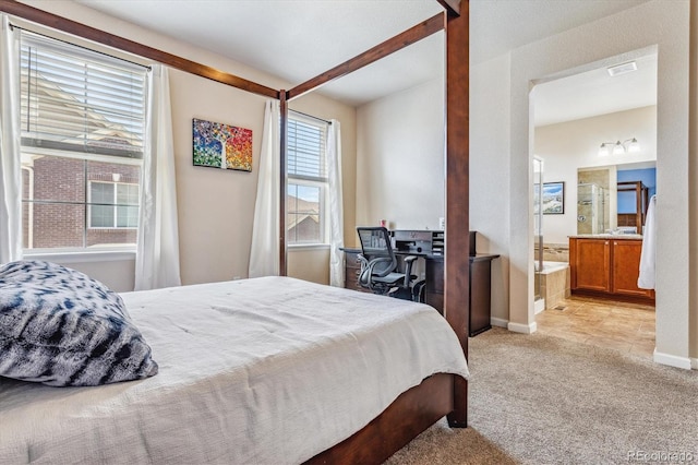 bedroom featuring ensuite bath, baseboards, light colored carpet, and visible vents