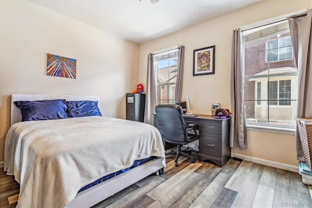 bedroom featuring baseboards and wood finished floors