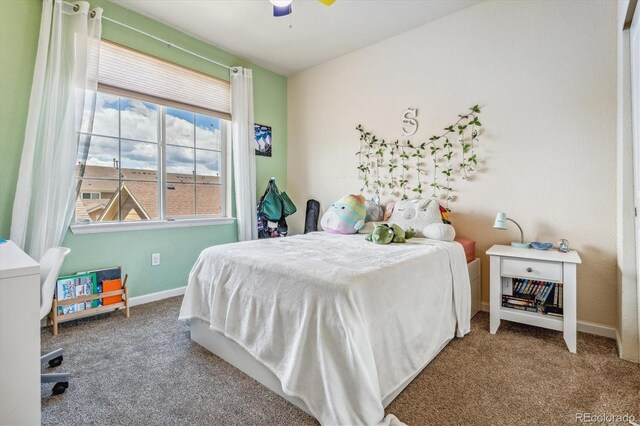 carpeted bedroom with baseboards and a ceiling fan