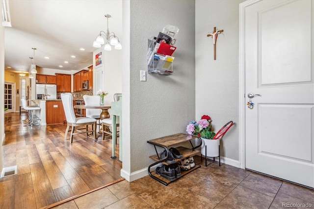interior space with baseboards, visible vents, a chandelier, and recessed lighting