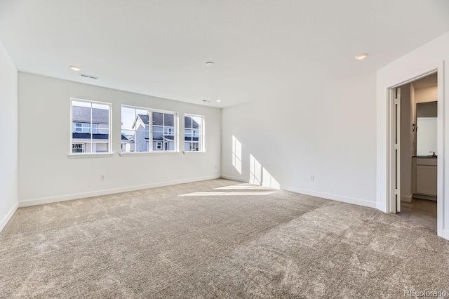 unfurnished living room with baseboards, visible vents, carpet flooring, and recessed lighting