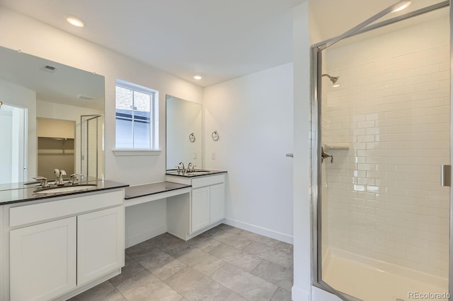 bathroom with visible vents, baseboards, vanity, a shower stall, and recessed lighting