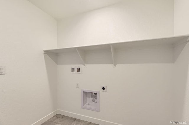 laundry room featuring laundry area, hookup for a washing machine, baseboards, and electric dryer hookup