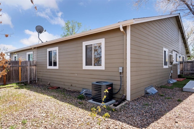 back of property with central AC and fence