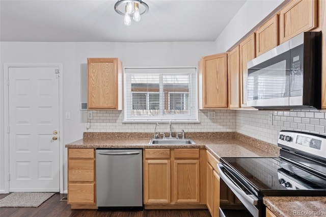 kitchen featuring dark wood-style flooring, light brown cabinets, a sink, backsplash, and stainless steel appliances