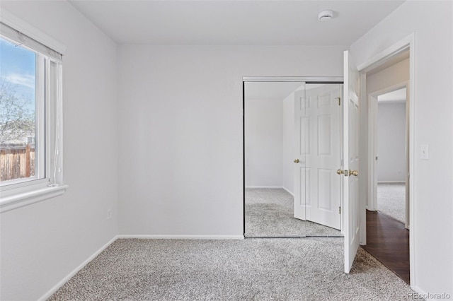 unfurnished bedroom with baseboards and carpet