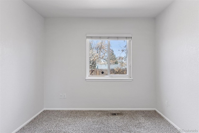 unfurnished room featuring visible vents, baseboards, and carpet floors