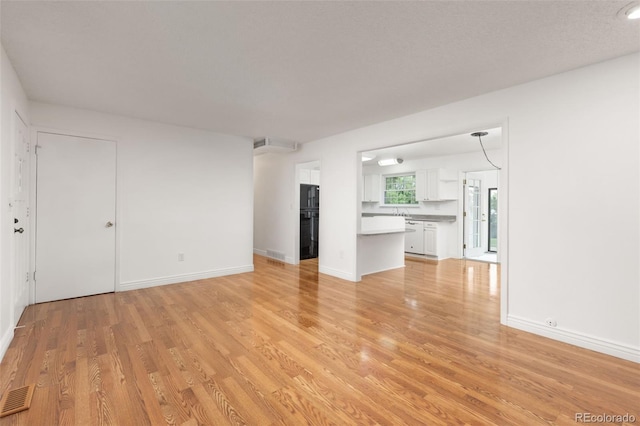 16839 E Amherst Ave E, Aurora, CO 80013 - unfurnished living room featuring light wood-type flooring and baseboards