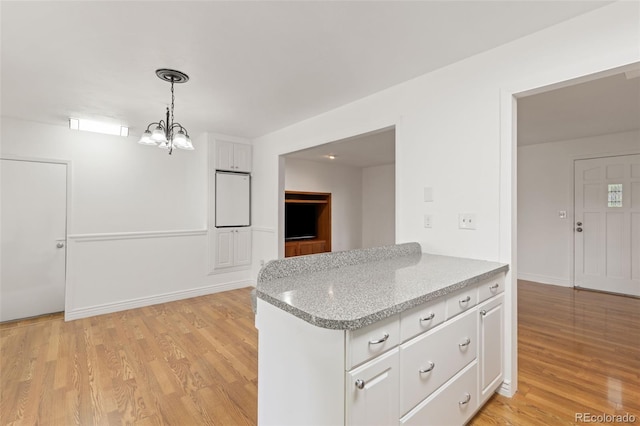 16839 E Amherst Ave E, Aurora, CO 80013 - kitchen featuring white cabinetry, a chandelier, light wood-style flooring, pendant lighting, and light stone countertops