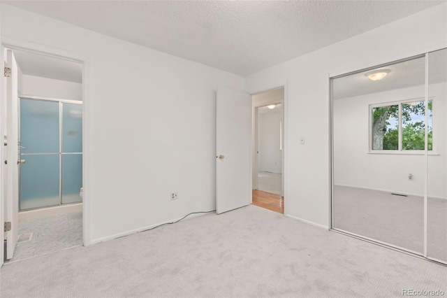 16839 E Amherst Ave E, Aurora, CO 80013 - unfurnished bedroom with carpet, a closet, and a textured ceiling