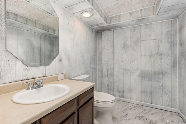 16839 E Amherst Ave E, Aurora, CO 80013 - bathroom featuring wood walls, vanity, and marble look tile flooring