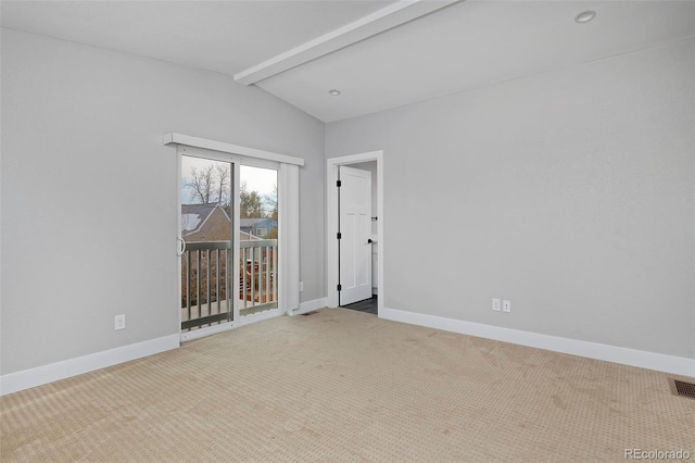 unfurnished room with carpet and vaulted ceiling with beams