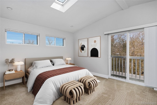 bedroom featuring access to exterior, lofted ceiling with skylight, and light colored carpet