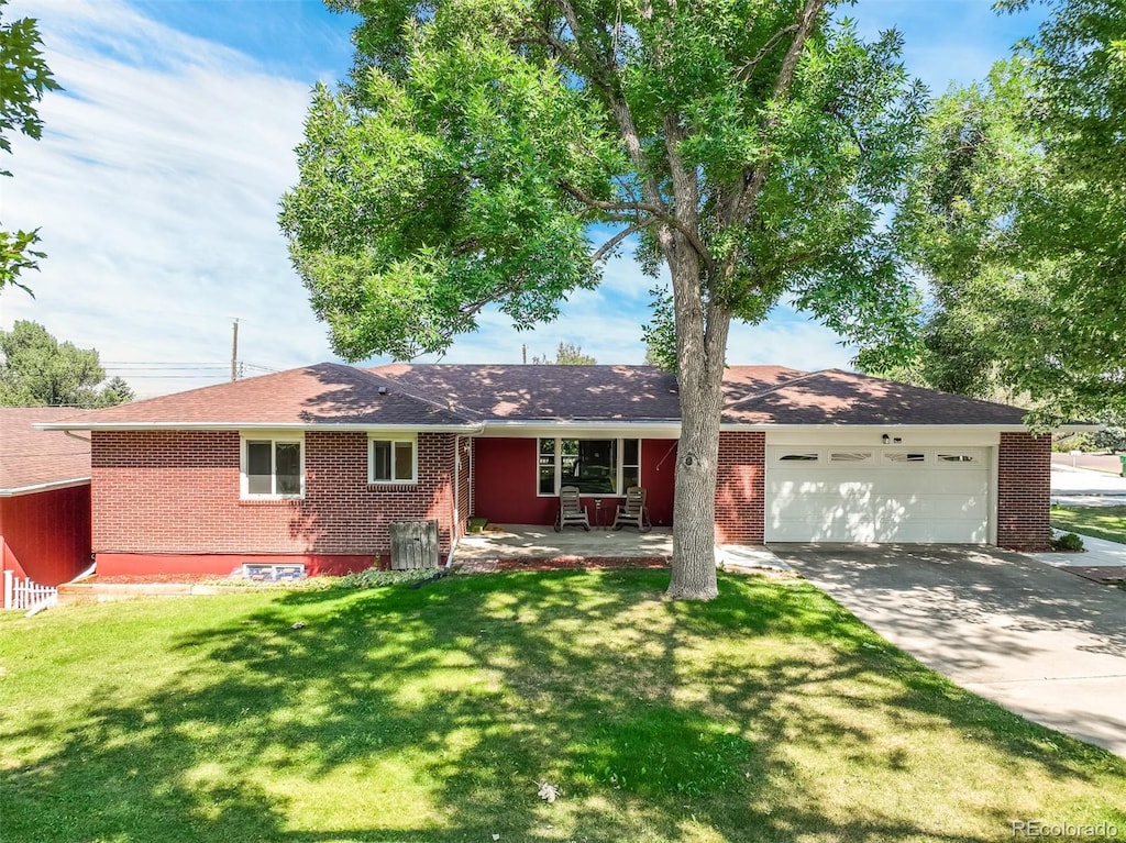 single story home with a garage and a front yard