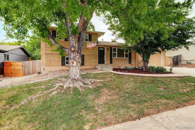 6640 S Dexter St, Centennial, CO 80121 - tri-level home featuring brick siding, a garage, and concrete driveway
