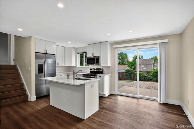 6640 S Dexter St, Centennial, CO 80121 - kitchen featuring stainless steel appliances, light countertops, dark wood-style flooring, tasteful backsplash, and recessed lighting