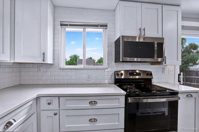 6640 S Dexter St, Centennial, CO 80121 - kitchen with appliances with stainless steel finishes, white cabinetry, decorative backsplash, and light countertops