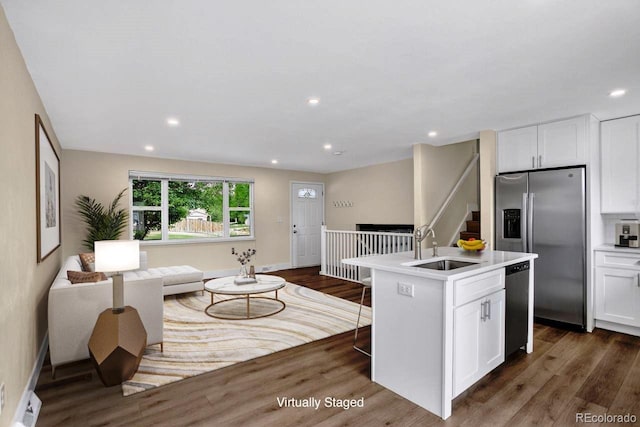 6640 S Dexter St, Centennial, CO 80121 - kitchen featuring stainless steel appliances, open floor plan, dark wood finished floors, white cabinetry, and recessed lighting