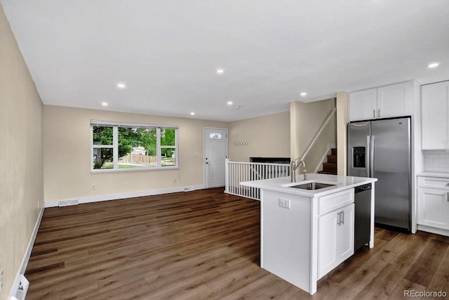 6640 S Dexter St, Centennial, CO 80121 - kitchen with stainless steel appliances, open floor plan, dark wood-style flooring, white cabinetry, and recessed lighting