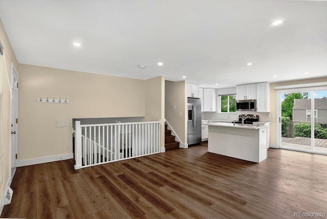 6640 S Dexter St, Centennial, CO 80121 - kitchen with stainless steel appliances, open floor plan, dark wood-style floors, light countertops, and white cabinets