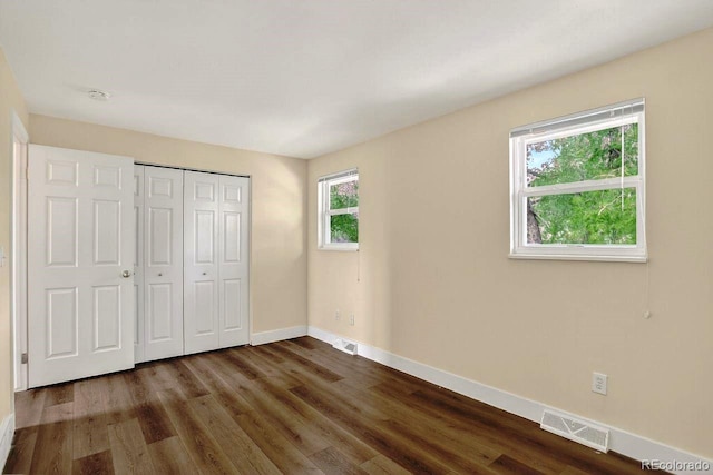 6640 S Dexter St, Centennial, CO 80121 - unfurnished bedroom featuring dark wood-style floors and a closet