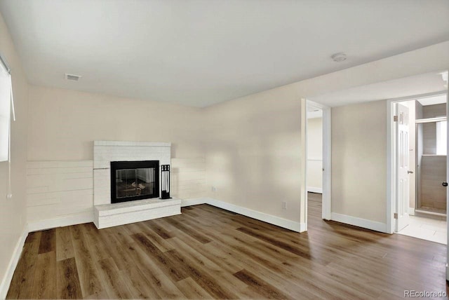 6640 S Dexter St, Centennial, CO 80121 - unfurnished living room featuring wood finished floors and a brick fireplace