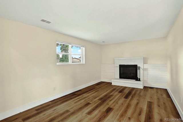 6640 S Dexter St, Centennial, CO 80121 - unfurnished living room featuring wood finished floors and a brick fireplace