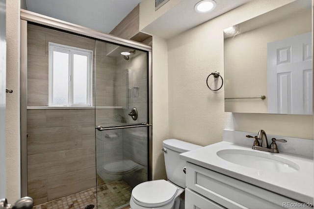 6640 S Dexter St, Centennial, CO 80121 - bathroom featuring a shower stall, vanity, and a textured wall