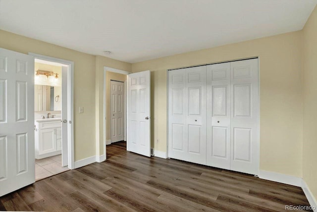 6640 S Dexter St, Centennial, CO 80121 - unfurnished bedroom with wood finished floors, a closet, and connected bathroom