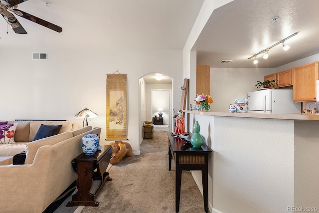 living room with light colored carpet and ceiling fan