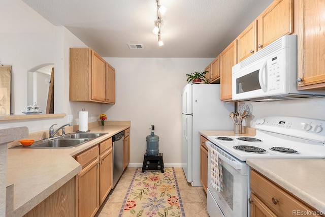 kitchen with sink, white appliances, and light tile patterned flooring