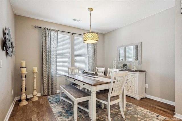 dining area with dark hardwood / wood-style flooring