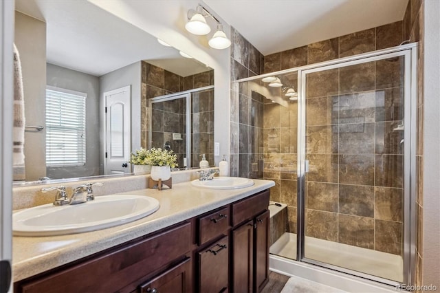 bathroom with vanity and a shower with door