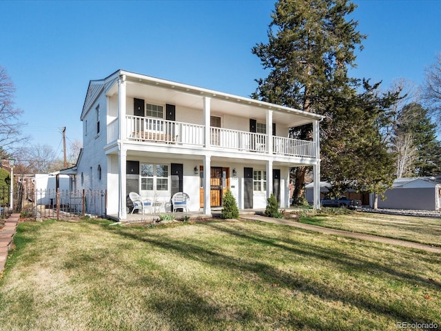 1100 Hudson St, Denver, CO 80220 - view of front of house featuring a balcony, a front lawn, and a porch