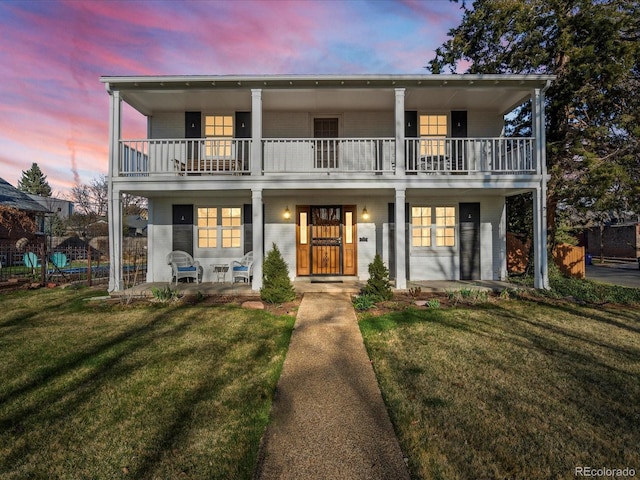 1100 Hudson St, Denver, CO 80220 - view of front of home with a balcony, covered porch, and a lawn