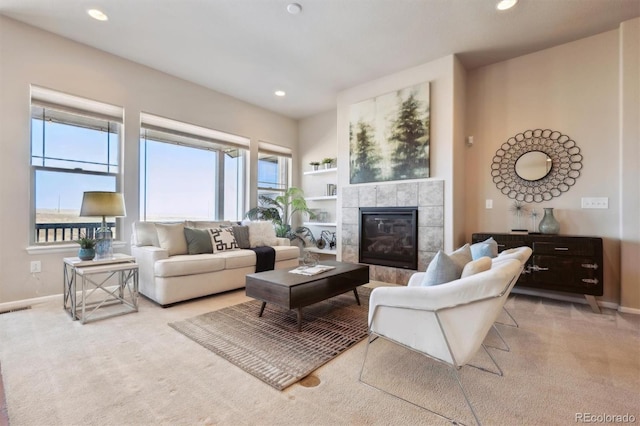 carpeted living room with baseboards, a tile fireplace, visible vents, and recessed lighting