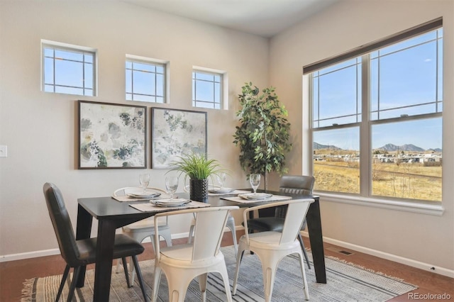 dining area featuring a mountain view, visible vents, and baseboards