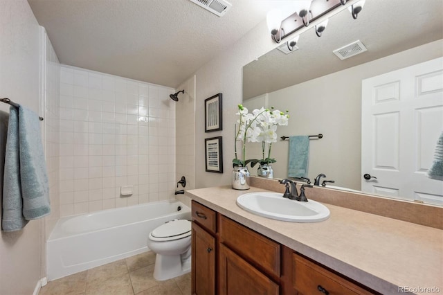 bathroom with toilet, vanity, tile patterned floors, and visible vents